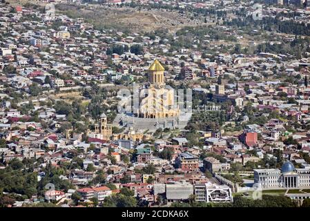 The Holy Trinity Cathedral of Tbilisi, panoramic view from  Mount Mtatsminda, with suburbs in the background. Republic of Georgia. Stock Photo