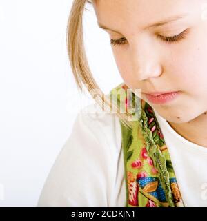 Head shot of a blond young girl looking down Stock Photo