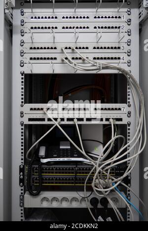 in a server rack are many patch panels and network cables and network switches Stock Photo