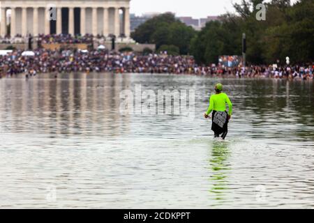 Washington, DC, USA, 28 August, 2020.  Pictured: Many attendees of the March on Washington gave into the temptation to cool off in the Reflecting Pool in front of the Lincoln Memorial due to the sweltering heat of the day.  Here a women has waded out into the middle of the pool, while others closer to the memorial have done the same..  Credit: Allison C Bailey/Alamy Credit: Allison Bailey/Alamy Live News Stock Photo