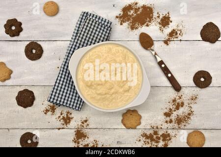 rice pudding and cinnamon with cookies on wooden table Stock Photo