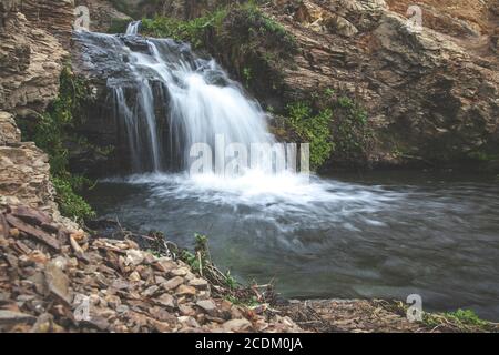 fresh water flows down dark rock at Alamere Falls in Point Reyes, California. Stock Photo