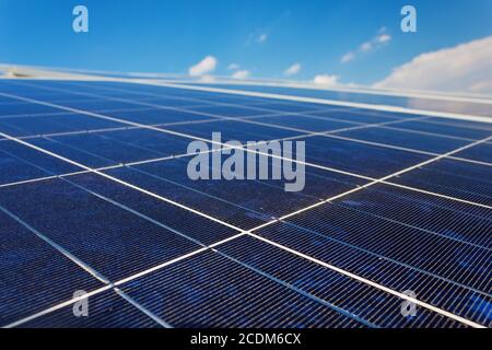 A roof with solar panels cells - detail. Solar panels producing clean and sustainable electricity. Solar panels against a serene Stock Photo