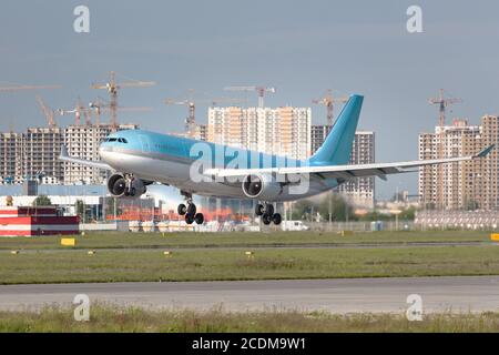 Closeup of modern passenger airplane ready for landing on runway at the airport in summer. Aviation, travel concept Stock Photo