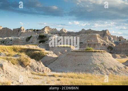 Sun shining on peaks with blue sky at Badlands National Park, South Dakota Stock Photo