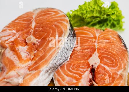 Raw Salmon Red Fish Steak with Herbs and Lemon on White Stock Photo