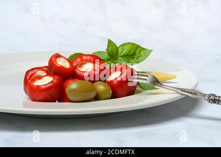 Cherry peppers stuffed with cream cheese on plate, antipasti, Germany Stock Photo