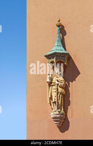 Saint Rochus of Montpelier, patron saint against plague, holding model of the church St. Sebald, statue under canopy made of copper with verdigris at Stock Photo