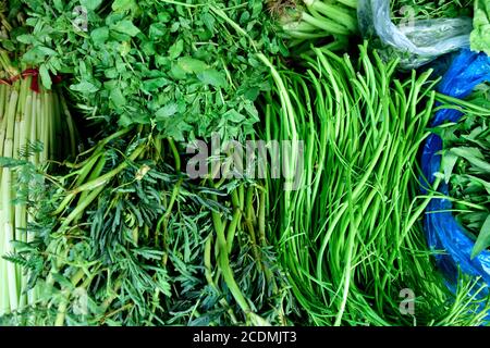 Vietnamese green vegetables, various locally grown fresh harvested raw green vegetables in a street market in Ho Chi Minh City, Vietnam Stock Photo