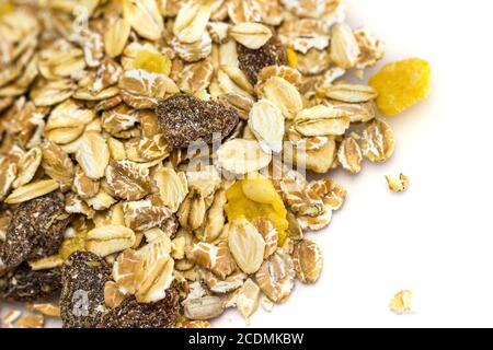 Heap of muesli isolated on white. Delicious granola cereal mix, with dried fruit and seeds. Stock Photo