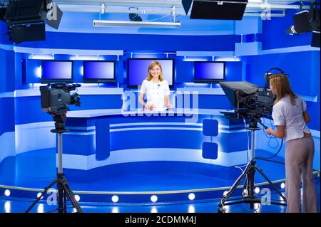television anchorwoman and teleoperator work at TV studio Stock Photo