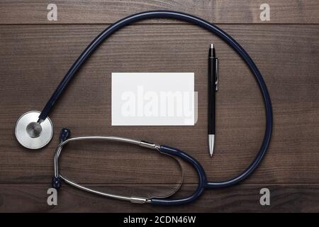 statoscope and notebook with ball pen on wooden table Stock Photo