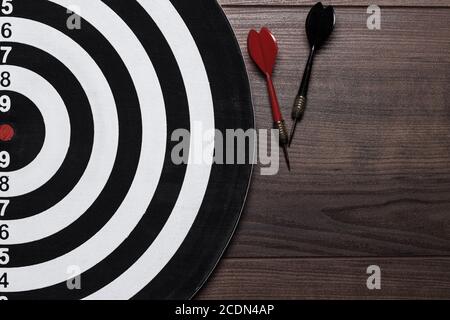target and two darts on wooden background Stock Photo