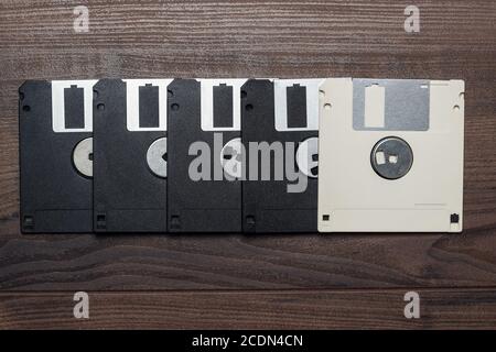 retro diskettes on wooden background Stock Photo