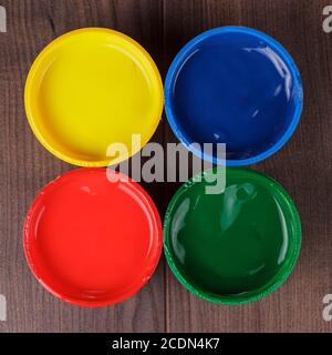 cans with paint on the wooden table Stock Photo