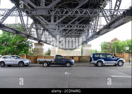 View of Harbour Bridge Structure underneath on a cloudy summer afternoon Stock Photo