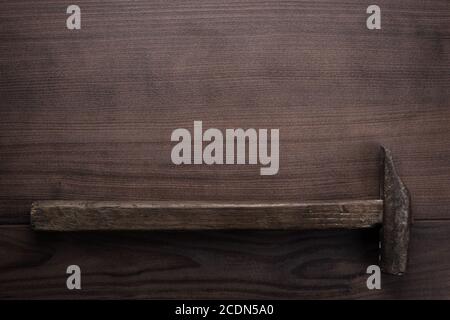 old rusty hammer on wooden background Stock Photo