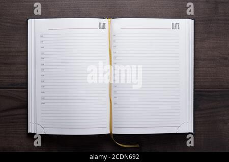 opened notebook on the wooden table Stock Photo