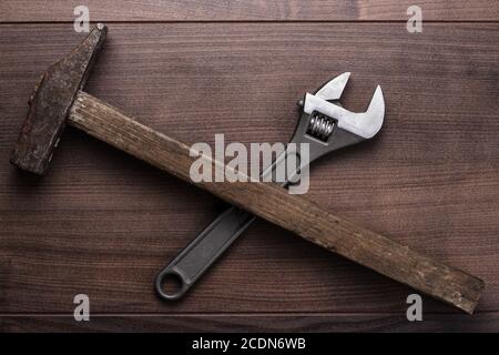 old rusty hammer and wrench on the table Stock Photo