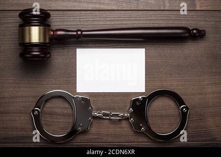 handcuffs and judge gavel on wooden background Stock Photo