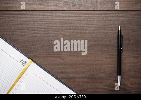 opened notebook and pen on wooden table Stock Photo