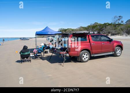 4WDs parked on beach with people fishing and relaxing, Burrum National park Queensland, Australia Stock Photo