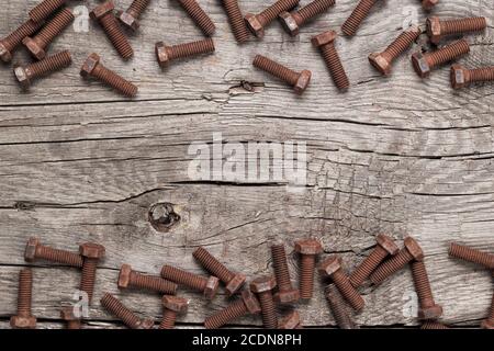 rusty screw bolt on the wooden table Stock Photo
