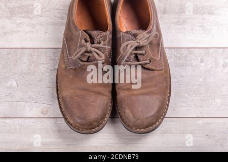 Brown men#39;s shoes on a wooden background Stock Photo