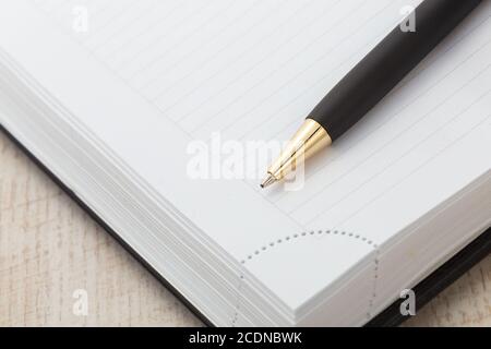 Notepad with ball pen on a white background Stock Photo - Alamy