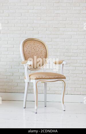 Luxury Golden Vintage Chair On Brick Wall Stock Photo