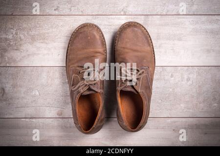 Brown men#39;s shoes on a wooden background Stock Photo