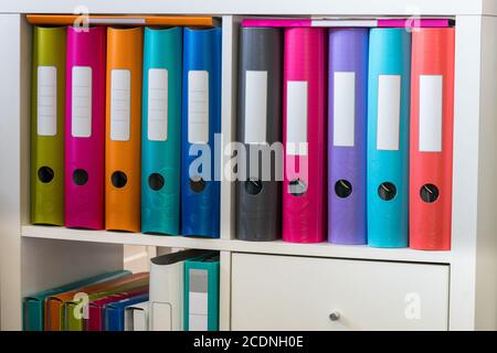 A cabinet with colorful folders and folders for office documents Stock Photo