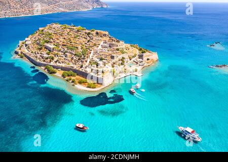 View of the island of Spinalonga with calm sea. Here were isolated lepers, humans with the Hansen's desease, gulf of Elounda, Crete, Greece. Stock Photo