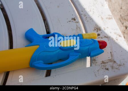 water gun on sun lounger on the beach Stock Photo