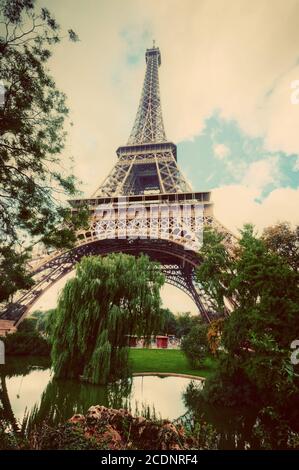 Eiffel Tower from Champ de Mars park in Paris, France. Vintage Stock Photo