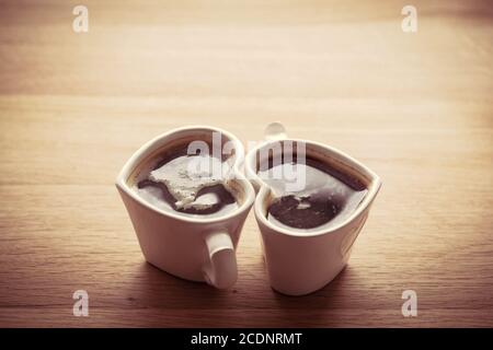 Black coffee, espresso in two heart shaped cups.. Love, Valentine#39;s Day, vintage Stock Photo