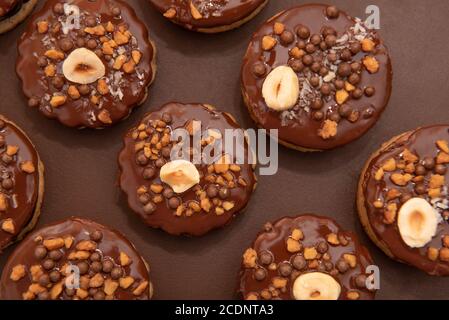 Brown Isler (or Ischler, Ishler) Cookies with hazelnuts and peanut brittle on brown background, dating back to Austro-Hungarian Empire Stock Photo
