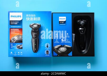 ZhongShan China-August 28 2020:top view box of brand new electric shaver on a blue background. Stock Photo