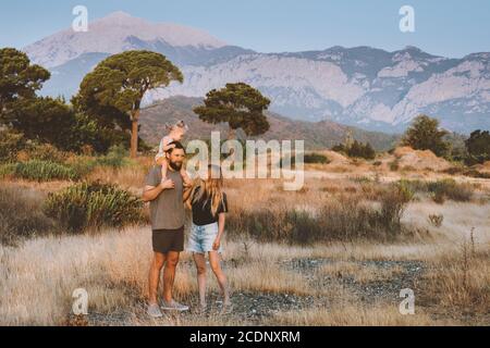 Family vacations parents with baby traveling in Turkey outdoor couple hiking Lycian way travel summer holidays mother and father with child having fun Stock Photo