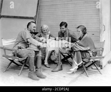 DONALD CRISP JEAN HARLOW CLARK GABLE and MARY ASTOR on set candid during filming of RED DUST 1932 director VICTOR FLEMING screenplay John Lee Mahin Metro Goldwyn Mayer Stock Photo