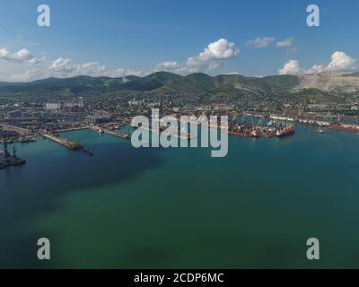 Industrial seaport, top view. Port cranes and cargo ships and barges. Industrial seaport, top view. Port cranes and cargo ships Stock Photo