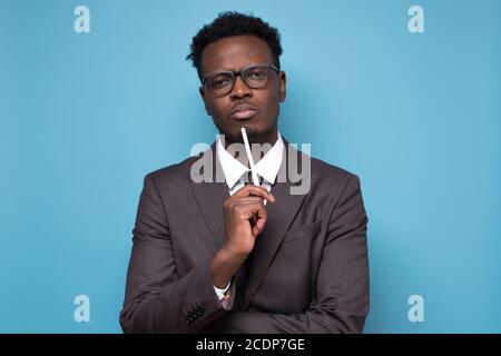 pensive african man thinking over something, trying to come up with solution Stock Photo