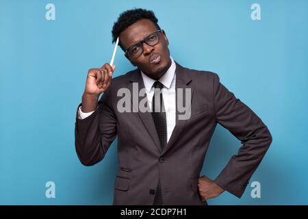 pensive african man thinking over something, trying to come up with solution Stock Photo