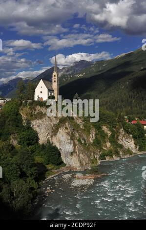 The Late Gothic Reformed Church of Saint George, consecrated in 1516 but with a Romanesque tower surviving from an earlier church, stands high on a rocky cliff above the River Inn flowing through the Romansh-speaking spa town of Scuol in the Lower Engadine Valley,Graubünden or Grisons canton, Switzerland.
