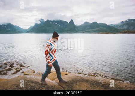 Man tourist walking on beach traveling in Norway active vacations outdoor healthy lifestyle explore Lofoten islands Stock Photo
