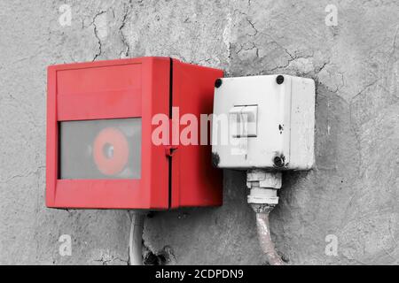 emergency switch and light switch on the wall of a factory building Stock Photo