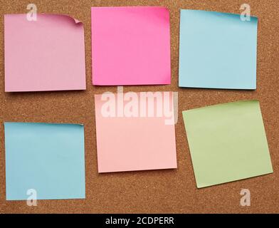 colorful paper stickers glued on brown balsa board, idea and multitasking, close up Stock Photo