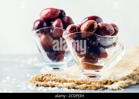 Large greek kalamata olives, gray background, selective focus Stock Photo