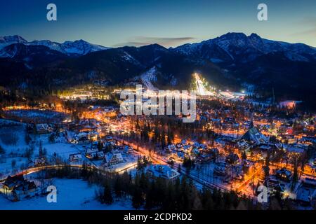 Stunning illuminated Zakopane city at night in winter, drone view, Poland Stock Photo