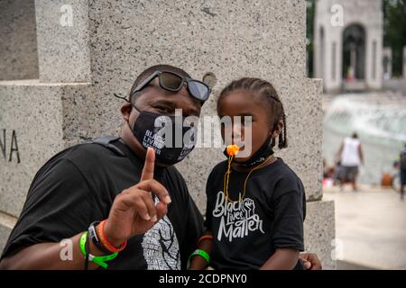 Washington, USA. 28th Aug, 2020. A man and his child attend a protest of police brutality at the Lincoln Memorial in Washington, DC in Washington, D.C, on August 28, 2020. (Photo by Matthew Rodier/Sipa USA) Credit: Sipa USA/Alamy Live News Stock Photo